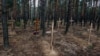 UKRAINE – A mass burial of the dead soldiers of the Armed Forces of Ukraine near Izyum, Ukraine, Sept. 15, 2022

