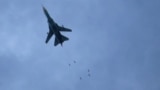 SYRIA -- A Syrian air force MiG-23 jet drops a payload during a reported regime air strike in the rebel-held town of Arbin, in the besieged Eastern Ghouta region on the outskirts of the capital Damascus, February 7, 2018