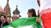Iran's national football team fans cheer outside the Kremlin in Moscow on June 13, 2018, ahead of the Russia 2018 World Cup football tournament.