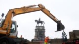 U.S. -- Workers for The Virginia Department of General Services install concrete barriers around the statue of Confederate General Robert E. Lee on Monument Avenue Wednesday, June 17, 2020, in Richmond,