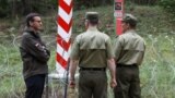 Polish PM Mateusz Morawiecki (L) meets with border guards on the Polish-belarusian border during the migration crisis, August 2021