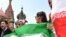 Iran's national football team fans cheer outside the Kremlin in Moscow on June 13, 2018, ahead of the Russia 2018 World Cup football tournament.