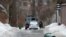 RUSSIA -- Law enforcement officers guard an area where, a man who barricaded himself in a private house opened fire on police, in the village of Novye Veshki, March 30, 2021