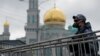 RUSSIA -- A law enforcement officer stands guard outside the closed Moscow Cathedral Mosque during Eid al-Fitr, the Muslim festival marking the end the holy fasting month of Ramadan, amid the coronavirus disease (COVID-19) outbreak in Moscow, May 24, 2020