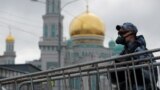 RUSSIA -- A law enforcement officer stands guard outside the closed Moscow Cathedral Mosque during Eid al-Fitr, the Muslim festival marking the end the holy fasting month of Ramadan, amid the coronavirus disease (COVID-19) outbreak in Moscow, May 24, 2020