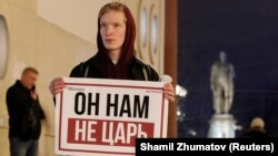 Holding a poster that reads "He's not our tsar," a Moscow activist stages a one-person protest against proposed constitutional amendments that would allow Russian leader Vladimir Putin to run for an additional two terms as president. 