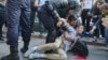 RUSSIA -- Timur Olevskiy, a TV anchor for Current Time TV, conducts an interview with a man as he is being detained by police at a rally to demand free municipal elections in Moscow, August 3, 2019