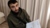 POLAND -- Tumso Abdurakhmanov, the 32-year-old Chechen video blogger, and critic of the Chechen ruler Ramzan Kadyrov, holds a letter from Interpol during an interview with The Associated Press somewhere in Poland, November 14, 2018
