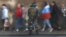 RUSSIA -- Protesters walk past an officer of the Russian National Guard during a rally against pension reforms, which envisage raising the retirement age, in St. Petersburg, Russia September 16, 2018