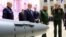 RUSSIA -- Russian President Vladimir Putin (C), Defense Minister Sergei Shoigu, and Chief of the General Staff Valery Gerasimov visit an exhibition at the Russian military's headquarters as part of a conference on the Russian campaign in Syria in Moscow, 