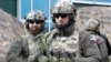 CHECHNYA -- Security officers guard an area as Chechen regional leader Ramzan Kadyrov tests a military buggy in Gudermes, 30 kilometers (19 miles) east of Chechen regional capital Grozny, February 26, 2019