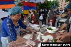 Refugees from Nagorno Karabakh bake the region's traditional, herb-stuffed flatbread in Yerevan to raise money for Karabakh.