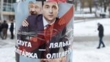 UKRAINE – A picture taken on February 8, 2019 shows people walking by placards depicting Ukrainian entertainer and presidential candidate Volodymyr Zelensky and oligarch Ihor Kolomoyskyi. Lviv, February 8, 2019