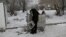 RUSSIA -- Bystrushkin, who is visually impaired and homeless, looks through a rubbish bin in Omsk, Russia, November 28, 2019. REUTERS/Alexey Malgavko   