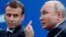 RUSSIA -- Russian President Vladimir Putin speaks as French President Emmanuel Macron looks at him at the St. Petersburg International Economic Forum in St. Petersburg, May 25, 2018