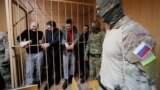 RUSSIA -- Detained crew members of Ukrainian naval ships, which were seized by Russia's FSB security service in November 2018, stand inside a defendants' cage as they attend a court hearing in Moscow, January 15, 2019