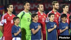 Armenian football players sing their national anthem before a Euro 2016 qualifying match against Albania in Yerevan in October 2015.