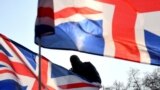 London, Britain - British flags / British flags fly near the Winston Churchill statue outside the Houses of Parliament during a pro-Brexit protest. March 29, 2019
