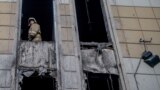 RUSSIA - A firefighter looks out from inside the fire-gutted shopping mall in the industrial city of Kemerovo in western Siberia on March 29, 2018