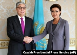 Then Interim President Qasym-Zhomart Toqaev and Dariga Nazarbaeva, ex-President Nazarbaev's eldest daughter, pose in Astana on March 20, 2019. Nazarbaeva, a member of parliament, has not been seen in public since the protests, allegedly for health reasons.