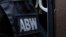 The Internal Security Agency (ABW) officers escort a man arrested on suspicion of spying