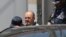 CHECHNYA --  Oyub Titiyev (C), the jailed director of the Russian human rights group Memorial's office in Chechnya, is escorted to a court in Grozny, July 3, 2018