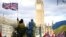 U.K. – A demonstrator holds a British flag during a protest against Russia's invasion of Ukraine, at Parliament Square in London, Britain, March 6, 2022