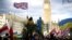 U.K. – A demonstrator holds a British flag during a protest against Russia's invasion of Ukraine, at Parliament Square in London, Britain, March 6, 2022