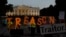 U.S. -- Activists hold letters reading the word "Treason" in front of the White House during a sunset demonstration to denounce the link between the 2016 Trump campaign and Russia, in Washington, July 29, 2018