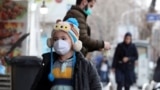 IRAN -- An Iranian child wearing face mask walks on a street of Tehran, February 26, 2020