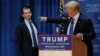 U.S. -- Then U.S. Republican presidential candidate Donald Trump (R) welcomes his son Donald Trump Jr. to the stage at one of the New England Council's "Politics and Eggs' breakfasts in Manchester, New Hampshire, November 11, 2015