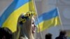UKRAINE – A pro-Ukrainian demonstrator attends a rally, back dropped by Ukraine's nation flag, in Simferopol, Ukraine, Saturday, March 15, 2014