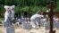ST PETERSBURG, RUSSIA - JULY 1, 2021: Workers in protective suits are seen during a funeral of deceased COVID-19 patients at the Novoye Kolpinskoye cemetery. Peter Kovalev/TASS