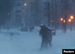 Велосипедист на московской улице во время снегопада вечером 12 февраля 2021 года. Фото: Reuters