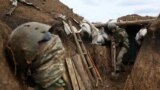 UKRAINE -- A Ukrainian serviceman digs the ground of a trench as he stands at his post on the frontline with Russia backed separatists near the town of Zolote, in the Luhansk region, April 8, 2021