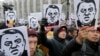 An anti-corruption rally in Bishkek on November 25 following the release of the investigative report. The man depicted in the placards is Raimbek Matraimov, who has filed a lawsuit against the media organizations responsible for the report.