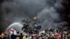 Ukraine -- Protesters stand behind barricades during a face-off against police in Kyiv, February 20, 2014