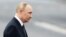 RUSSIA – Russia's President Vladimir Putin walks past a TV camera during a parade marking Navy Day in Saint Petersburg, July 31, 2022