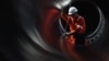 RUSSIA -- A worker is seen through a pipe at the construction site of the Nord Stream 2 gas pipeline, near the town of Kingisepp, Leningrad region, Russia, June 5, 2019. 
