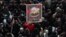 IRAN -- A portrait of slain Iranian Revolutionary Guards Corps (IRGC) Lieutenant general and commander of the Quds Force Qasem Soleimani is paraded as thousands of mourners gather to pay tribute for his funeral in Tehran, Iran, 06 January 2020. 