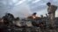 UKRAINE – People walk amongst the debris, at the crash site of a passenger plane near the village of Hrabove in the Donetsk region, July 17, 2014