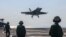 TOPSHOT - In this handout photograph released by the US Navy on February 6, 2026, an F/A-18F Super Hornet, attached to Strike Fighter Squadron (VFA) 41, makes an arrested landing on the flight deck of Nimitz-class aircraft carrier USS Abraham Lincoln in t