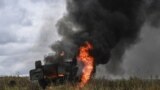 UKRAINE – Destroyed Russian MT-LB armoured personnel carrier burning in a field on the outskirts of Izyum, Kharkiv Region, September 14, 2022