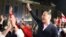 Former TV news anchor Zaal Udumashvili, one of the leaders of the United National Movement party, cheers as party supporters gather in front of Georgia's parliament building to "monitor" the vote count in the country's October 31, 2020 parliamentary election.