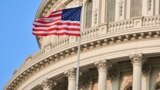 U.S. – Capitol Building dome detail with US flag waving