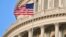 U.S. – Capitol Building dome detail with US flag waving
