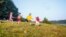 RUSSIA, YAROSLAVL - 03 JULY 2014: group happy children and teens let soap colored bubbles in summer forest tent camp play active games on banks Volga river participate in competitions bright sunny day --Shutterstock
