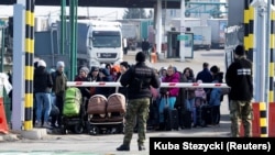 Люди, бегущие из Украины после начала войны, на польской границе 26 февраля 2022 года