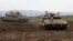 Israeli army Merkava tanks gather in the Israeli-annexed Golan Heights, on January 20, 2019. - Israel's military said its air defence systems intercepted a rocket fired from Syria today, after Damascus accused Israel of carrying out air raids. "A short wh