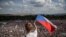 CZECH REPUBLIC -- A man waves Czech flag as thousands of demonstrators gather to protest against Czech Prime Minister Andrej Babis and new minister of justice, in the one of the biggest political demonstration against the government since the fall of comm